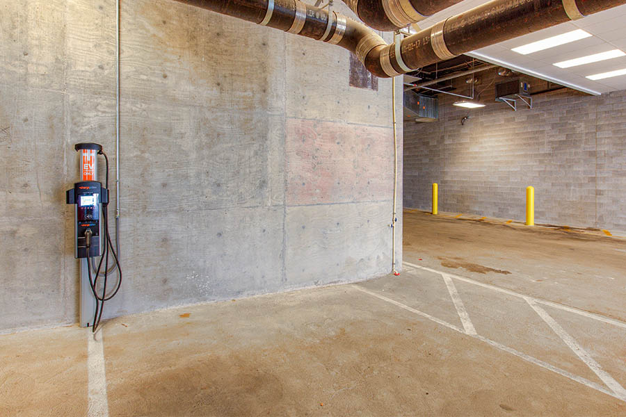 An EV charging station like this one in the parking garage at Penrose on Mass adds convenience to your life. EV charging station in parking garage