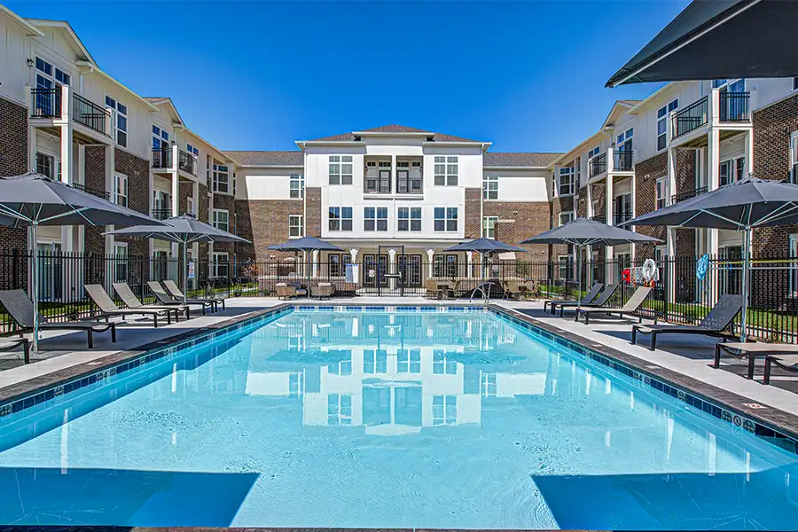 Pristine pool surrounded by apartment buildings at The Waverley Apartments.